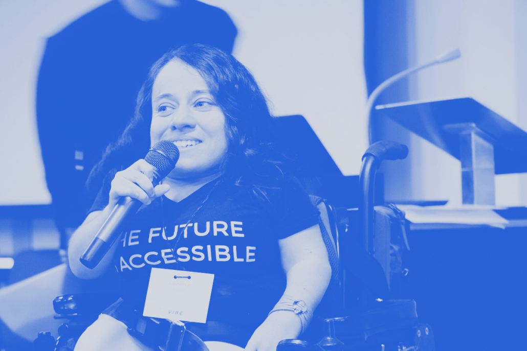 A person with a microphone and a t-shirt that reads: the future is accessible
